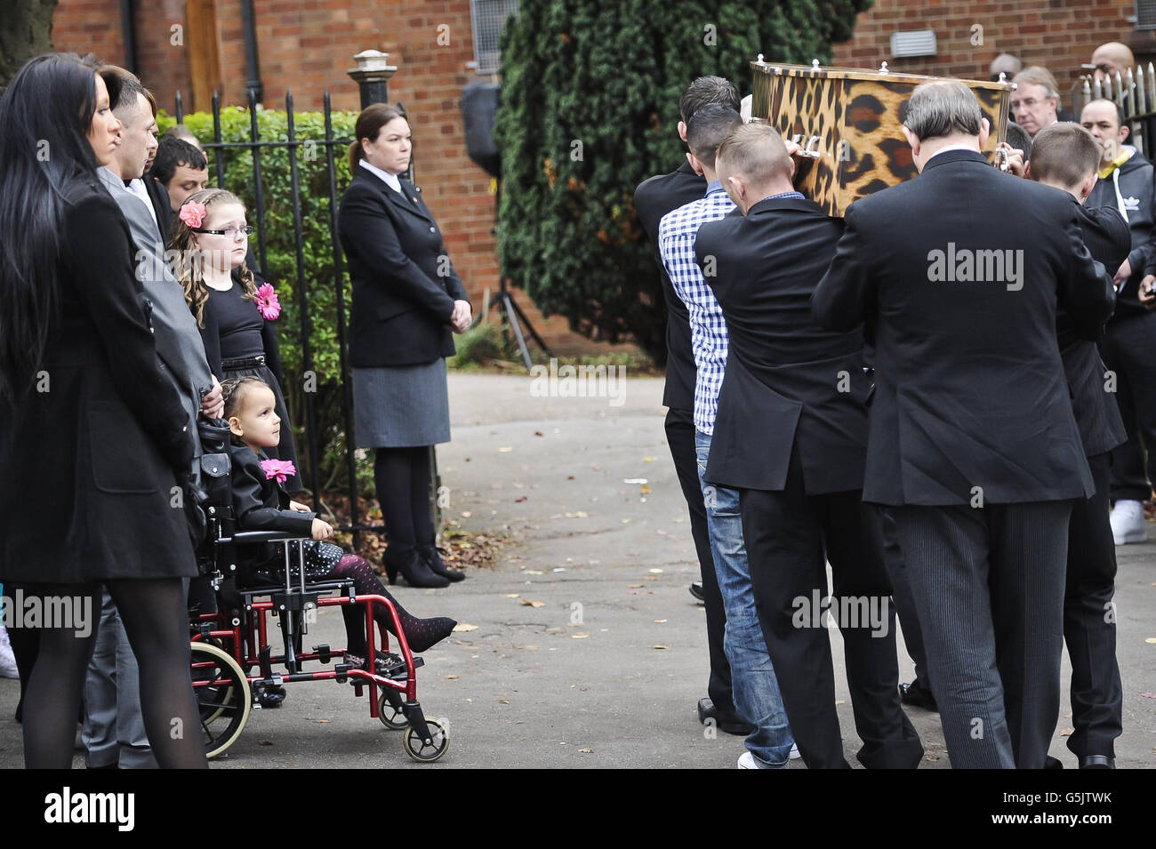Mourners, including the daughters of Karina Menzies watch the leopard skin style coffin containing Karina Menzies at the Church of Ressurection, Ely, near Cardiff. Stock Photo