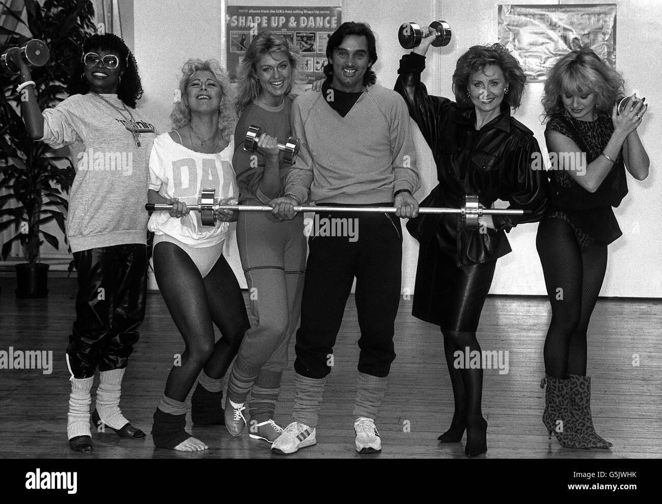1984: Lifestyle Records enters a new phase with the launch of five new 'Shape up and Dance' LPs featuring George Best and his girlfriend former Miss World Mary Stavin (3rd from left). The other four LPs are by Patti Boulaye (left), Suzanne Dando (2nd left), Lulu (2nd right) and Bucks Fizz singer Jay Aston (right). They are pictured at The Fitness Centre, Covent Garden, London. Stock Photo