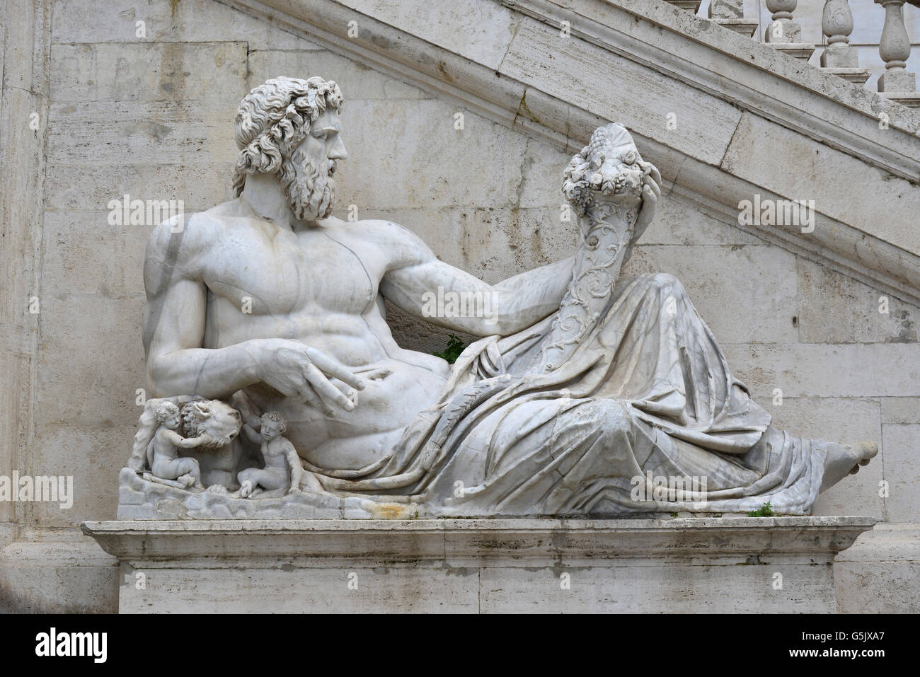 Ancient marble statue of River Tiber deity protects Romulus and Remus with his right arm, from Capitoline Hill Square, in the ce Stock Photo