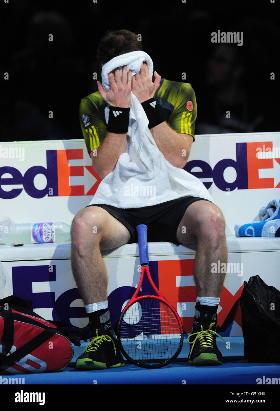 Great Britain's Andy Murray sits dejected after losing the first set to Switzerland's Roger Federer during the Barclays ATP World Tour Finals at the O2 Arena, London. Stock Photo