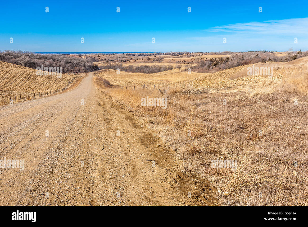 Winding gravel road through the rolling hills of western Iowa on the Stagecoach Trail of the Loess Hills National Scenic Byway Stock Photo