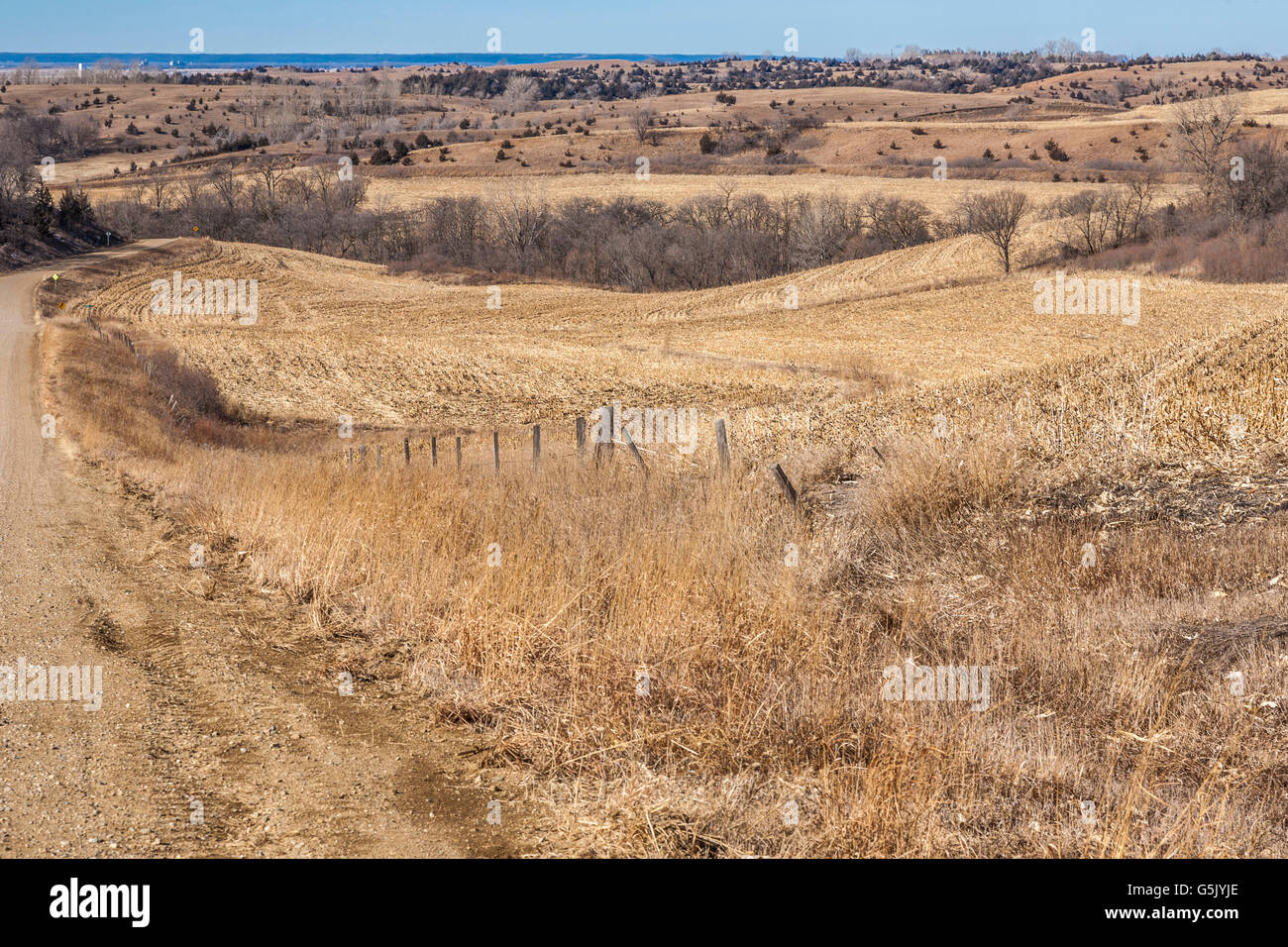 Winding gravel road through the rolling hills of western Iowa on the Stagecoach Trail of the Loess Hills National Scenic Byway Stock Photo