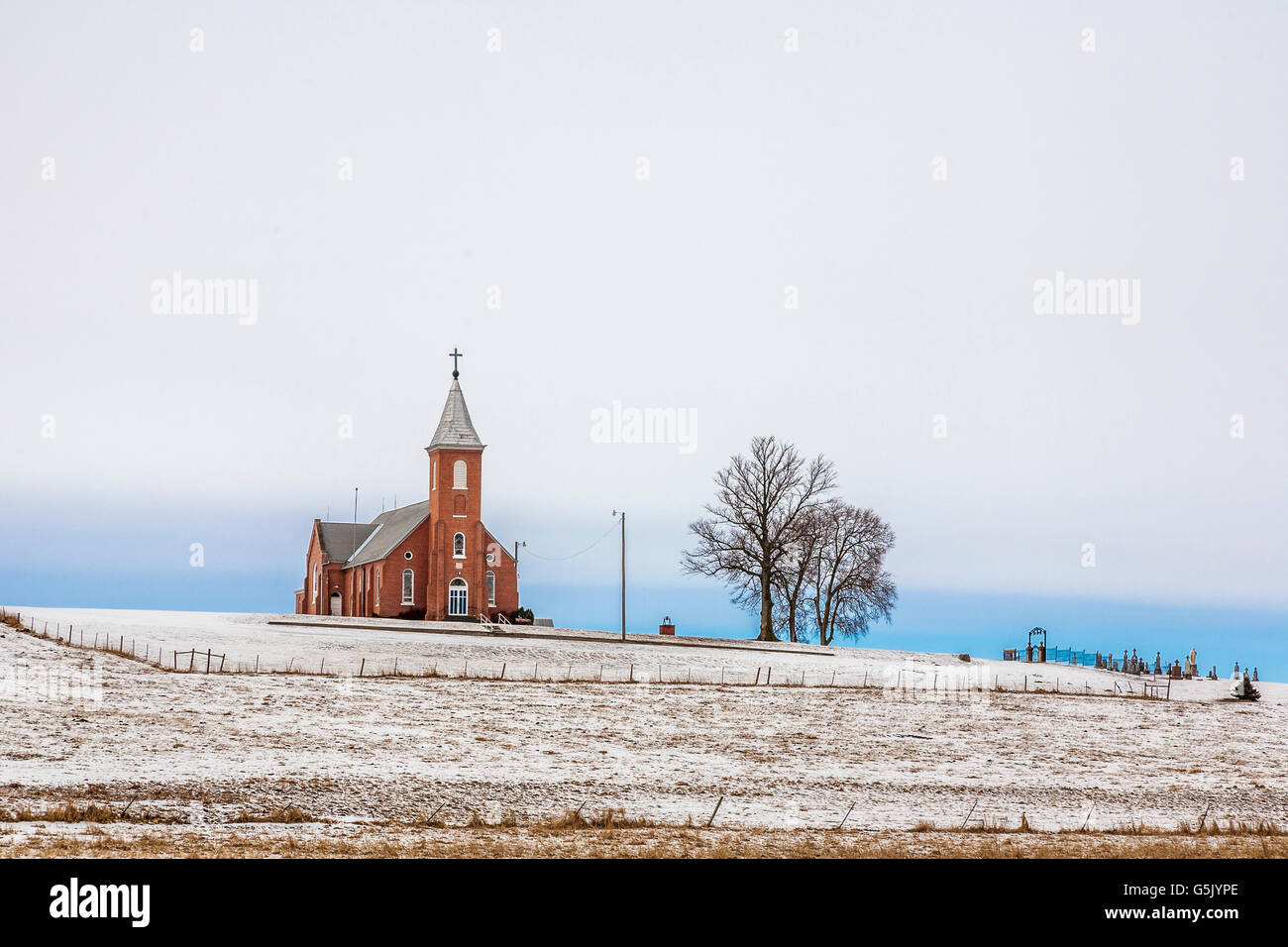 Church and cemetery on a hill surrounded by grain fields in rural north east Nebraska Stock Photo