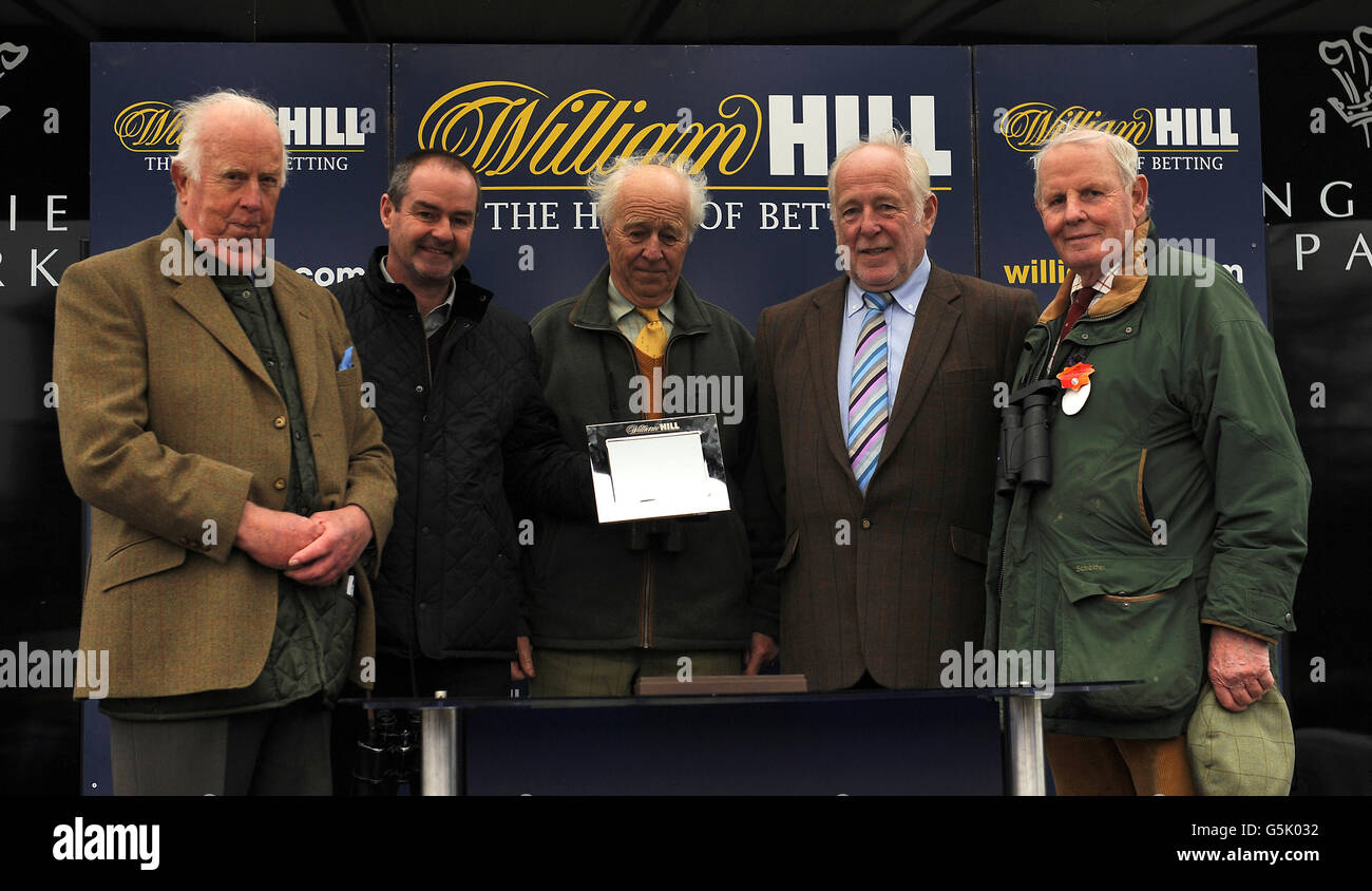 West Bromwich Albion manager Steve Clarke (2nd left) presents a trophy to winning connections of Dunlough Bay, winner of the William Hill 'the Jumps' Win 100,000 E.b.f. 'National Hunt' Novices' Hurdle at Lingfield Park Racecourse Stock Photo