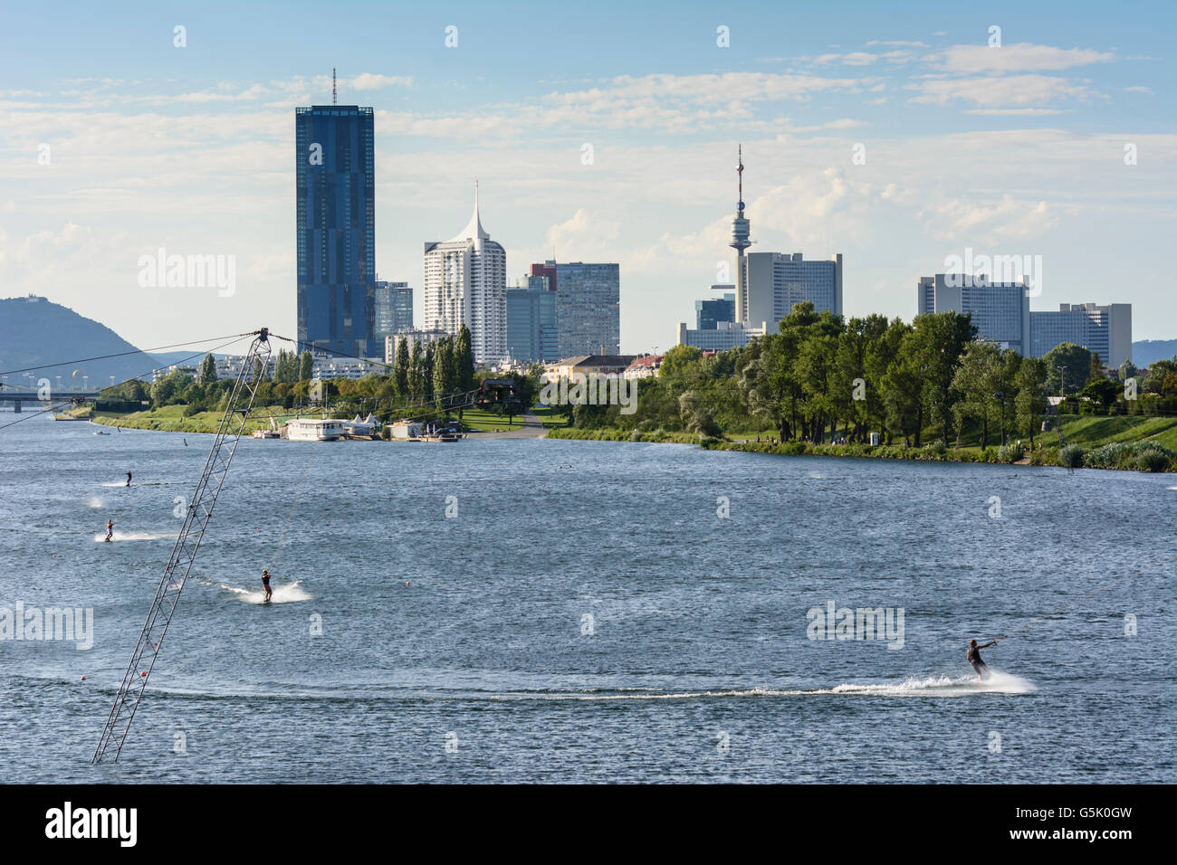 Wakeboarding with a water ski lift in the New Danube before the DC Tower 1 , the skyscraper New Danube and the Vienna Internatio Stock Photo