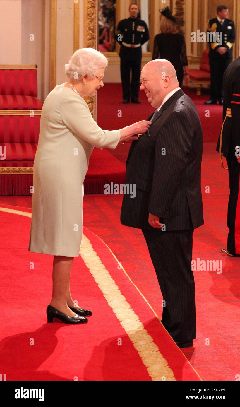 Joseph Anderson from Liverpool is made a Officer of the British Empire (OBE) by Queen Elizabeth II during an Investiture ceremony at Buckingham Palace in central London. Stock Photo