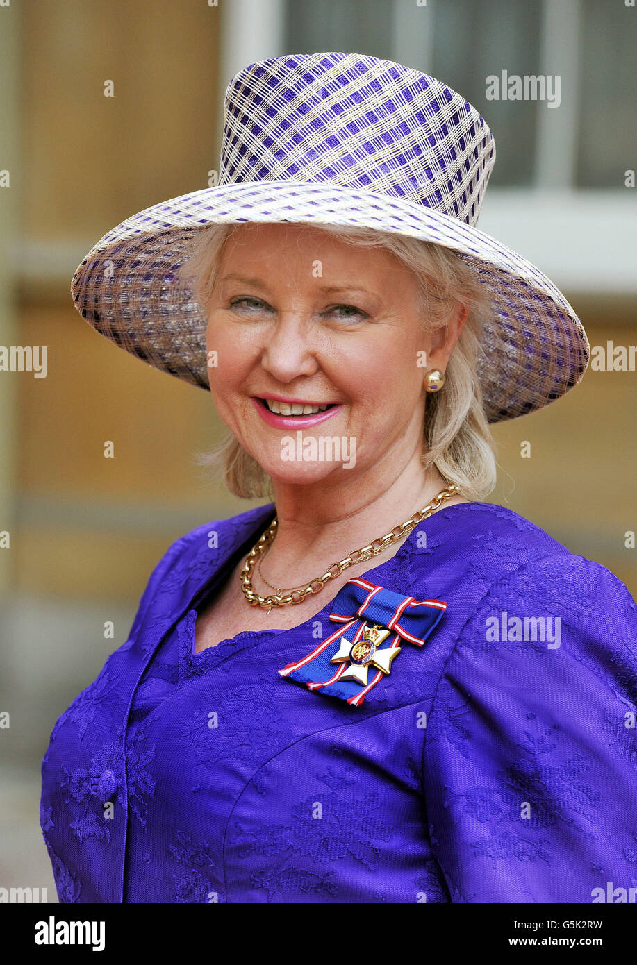 Angela Kelly the personnel dresser to Her Majesty proudly wears her Royal Victorian Order medal, after it was presented to her by Queen Elizabeth II, at the Investiture ceremony at Buckingham Palace in central London. Stock Photo