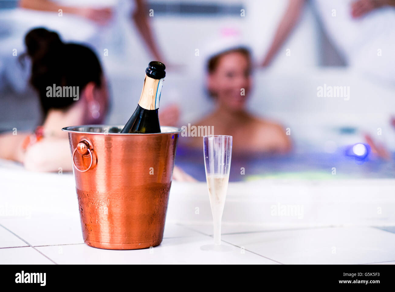 Glass and bottle of champagne in bucket, hen party Stock Photo
