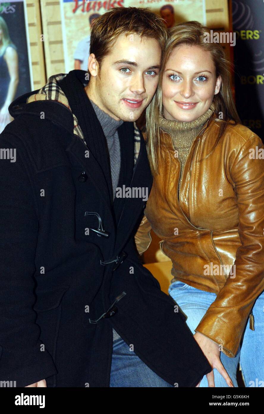 Actors Marcus Patrick and Joanna Taylor during the launch of the official 2002 calendar for the Channel Four soap Hollyoaks, at Borders Books in London's Oxford Street. Stock Photo