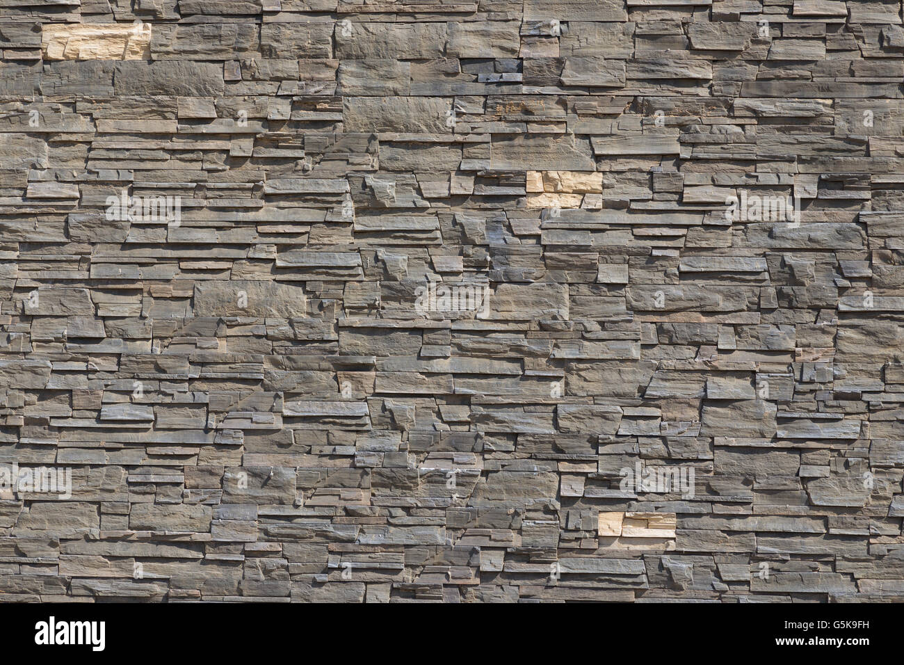 Decorative wall from grey stones Stock Photo - Alamy