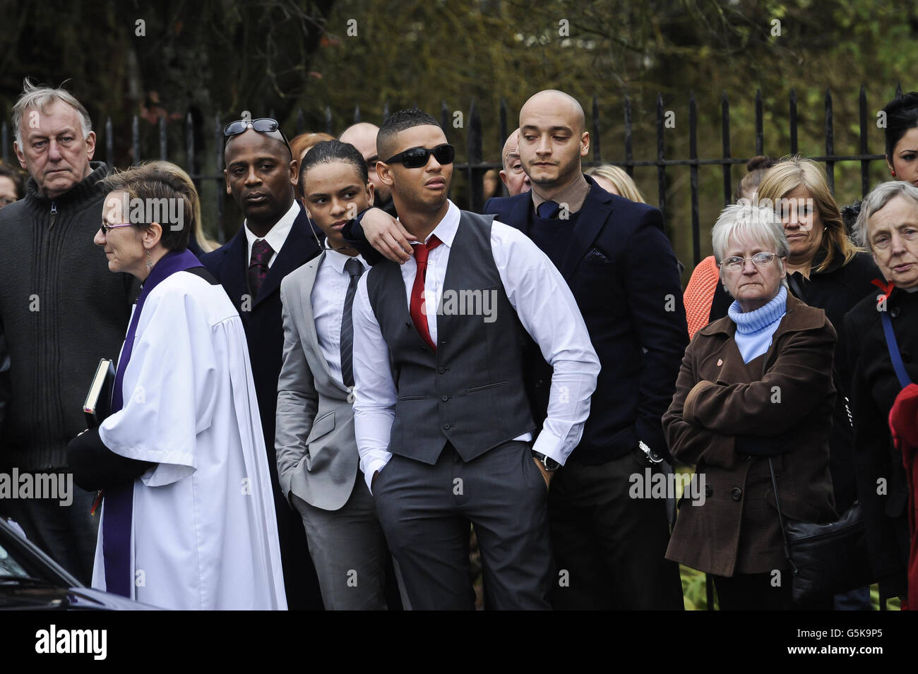 Mourners react as they watch the leopard skin style coffin containing Karina Menzies as it arrives at the Church of Ressurection, Ely, near Cardiff. Stock Photo