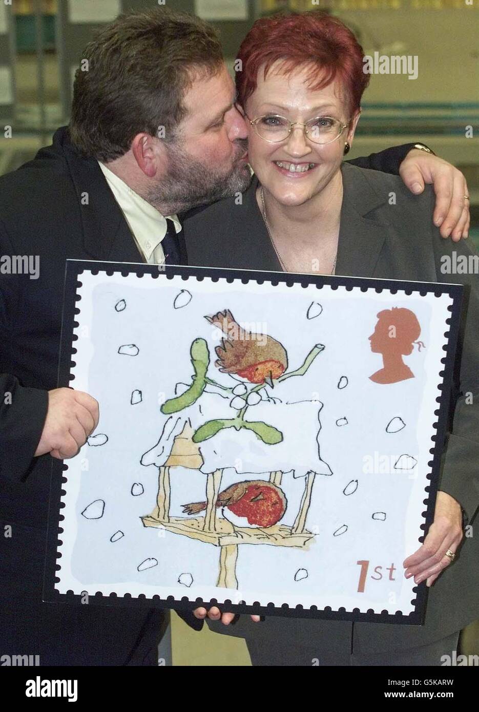 Carol Mitchell from Newcastle with her husband Ed, the secretary who was sent out by her boss to buy a stamp, celebrates in Gateshead, Newcastle upon Tyne, after she scooped 1 million in a Royal Mail promotion. * ..... The nationwide 1st Class Christmas Stamp promotion guaranteed 1 million to the finder of a special stamp. Although asked to buy just one stamp Carol, 50, decided to buy a book while in the shop and after keeping the remaining stamps one turned out to be the mystery million pound winner. Stock Photo