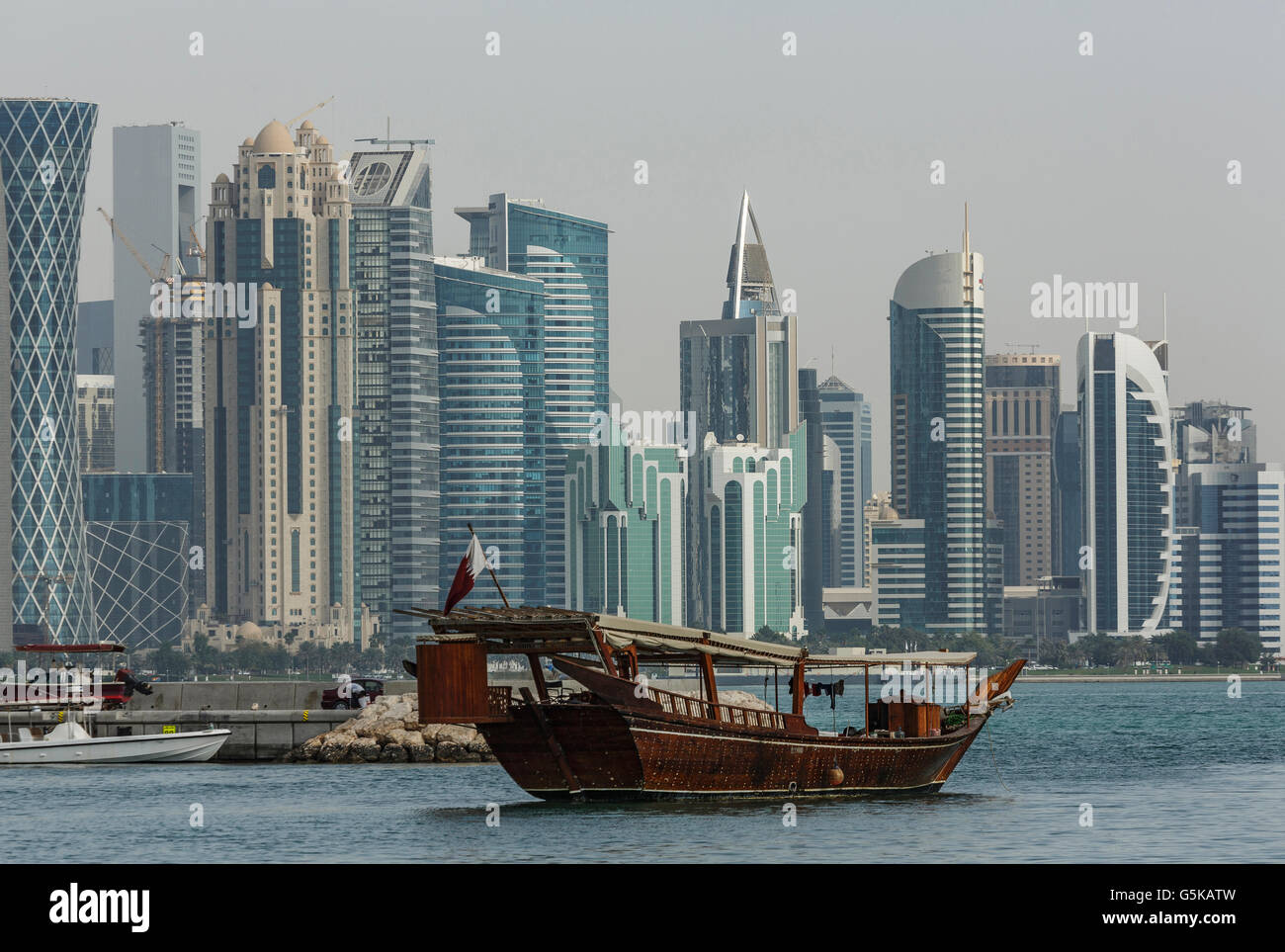 Boat floating near Doha skyline, Doha, Qatar Stock Photo