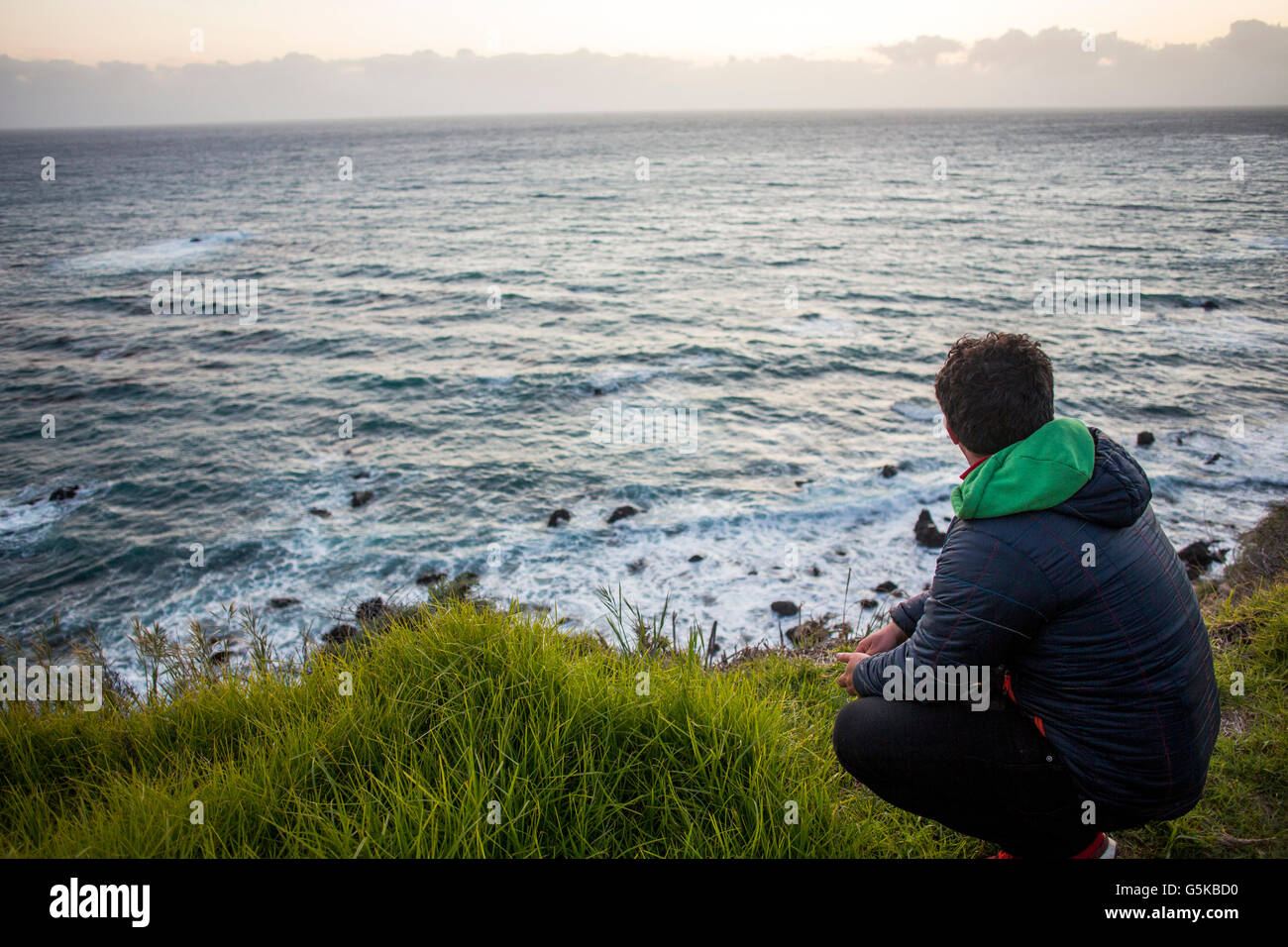 Caucasian man admiring ocean horizon Stock Photo
