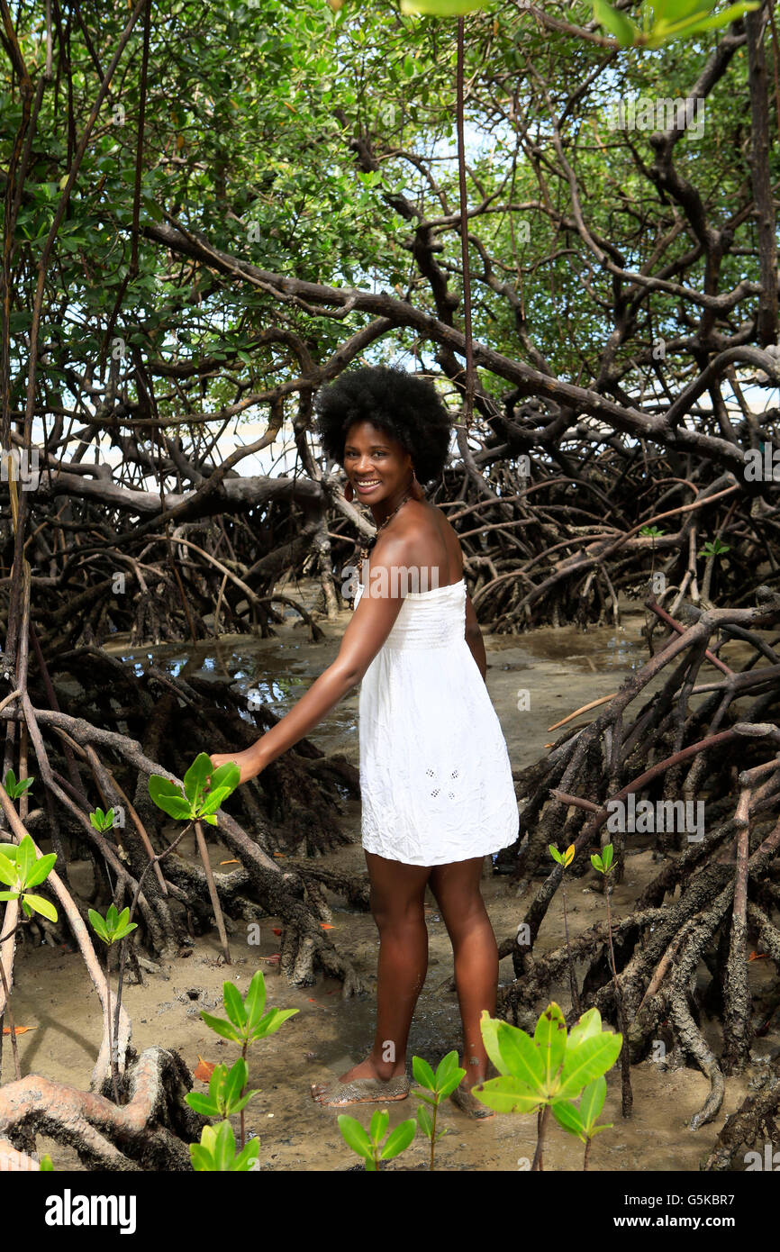Black woman smiling in mangrove jungle Stock Photo