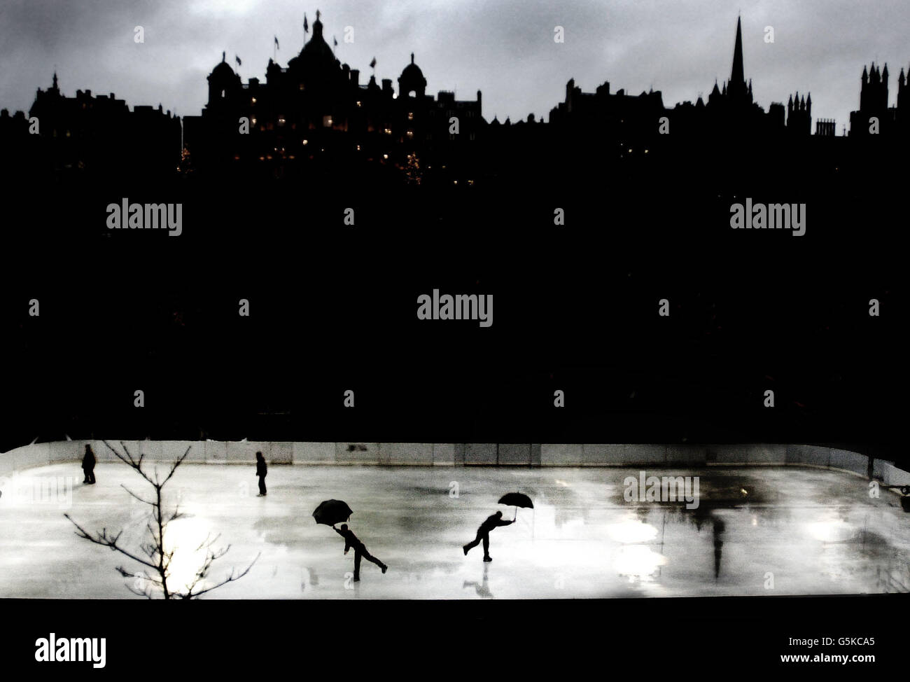 A young skater tries out the ice in heavy rain at a new open air rink ...