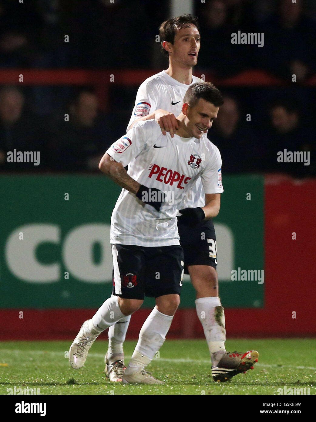 Leyton Orient's Dean Cox celebrates scoring the second goal with David Mooney who scored the first during the FA Cup First Round match at Whaddon Road, Gloucester. Stock Photo