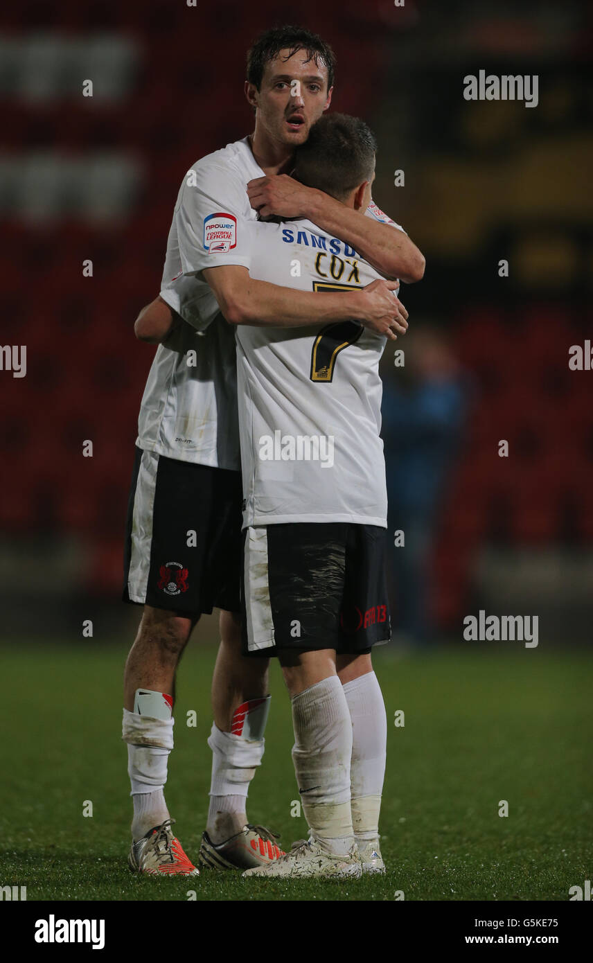 Leyton Orient's David Mooney who scored the 1st hugs Dean Cox who scored the 2nd during the FA Cup First Round match at Whaddon Road, Gloucester. Stock Photo