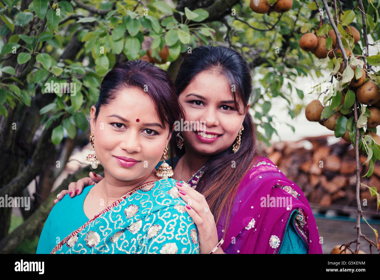 Women wearing traditional Indian dresses in garden Stock Photo