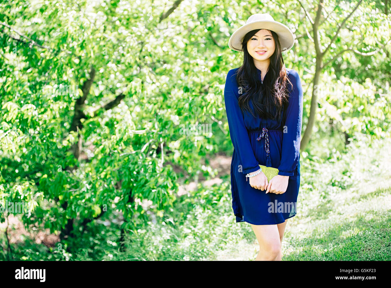Chinese woman standing in garden Stock Photo