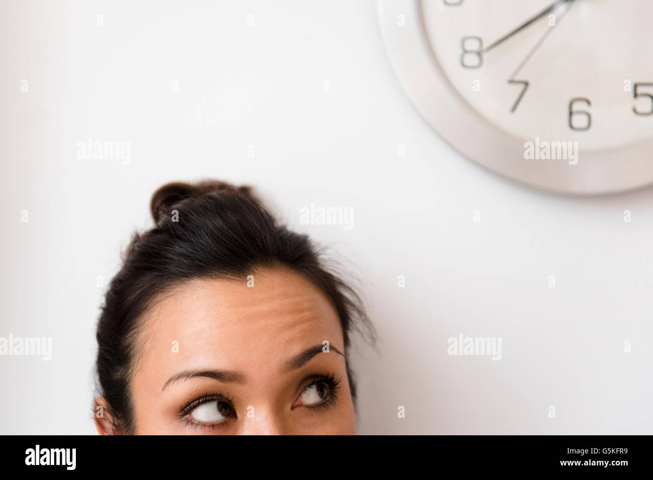 Woman looking at clock Stock Photo Alamy