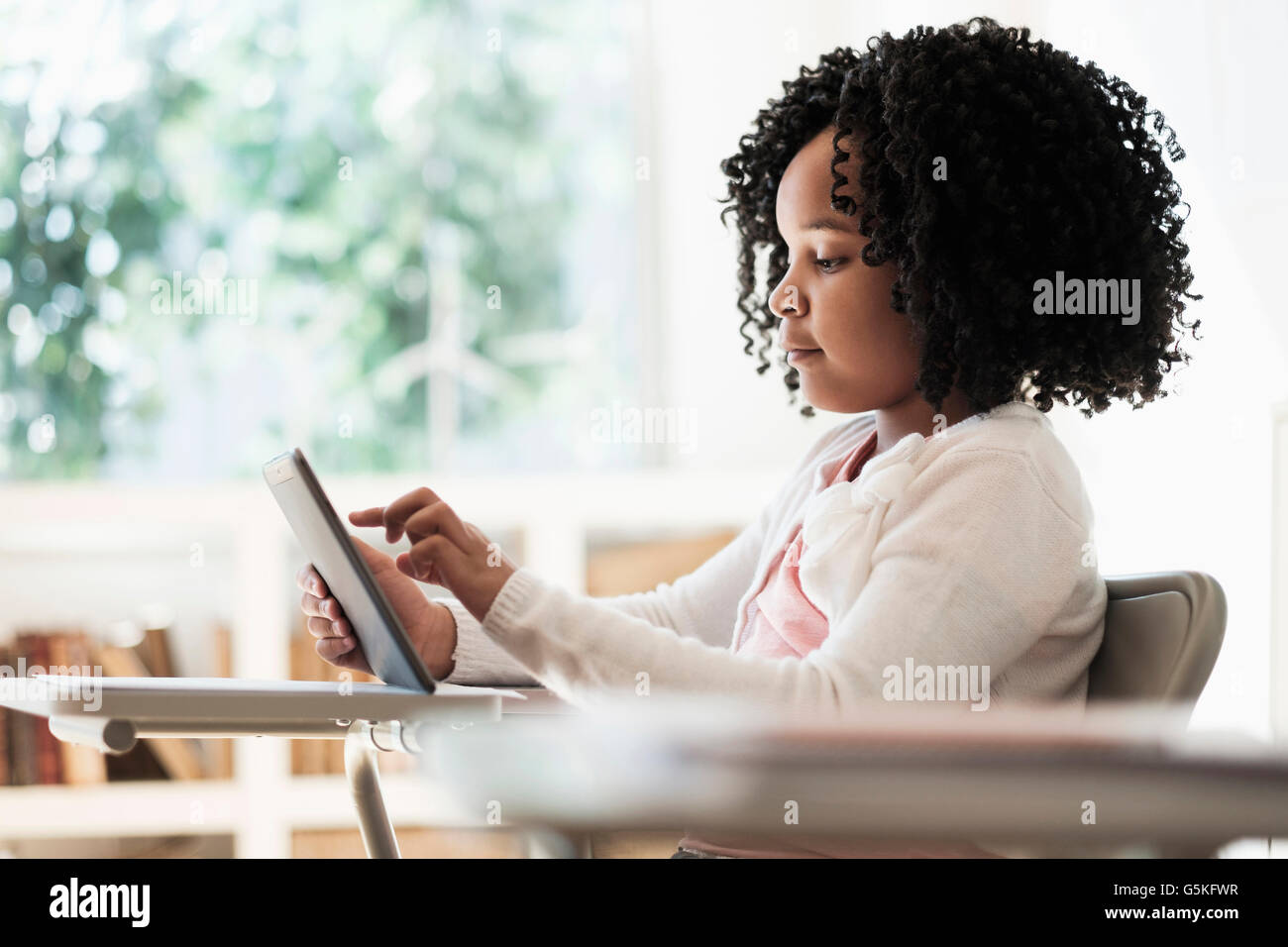 African American student using digital tablet in classroom Stock Photo