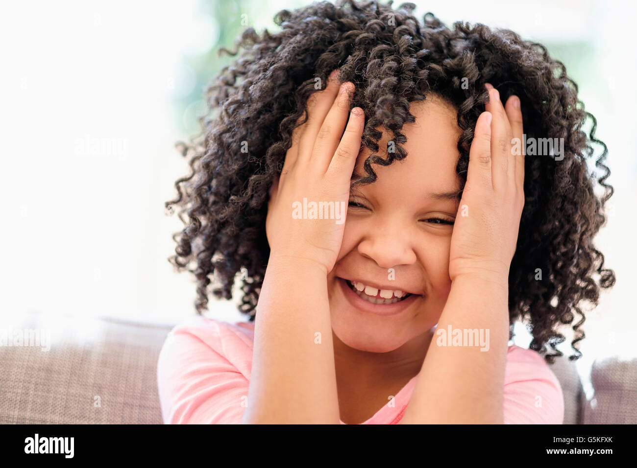 African American girl tossing her hair Stock Photo