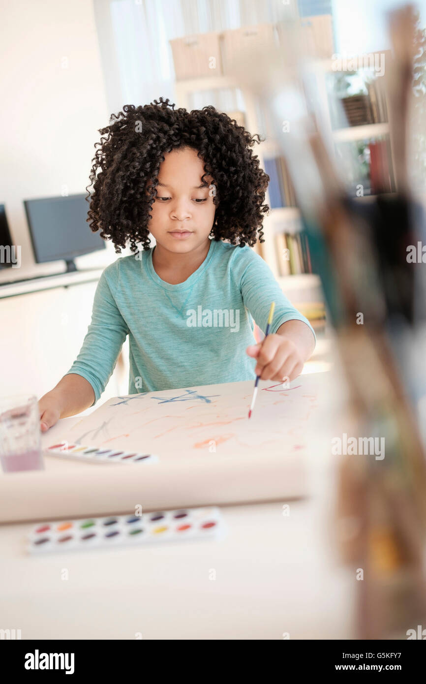 African American girl painting with watercolors Stock Photo