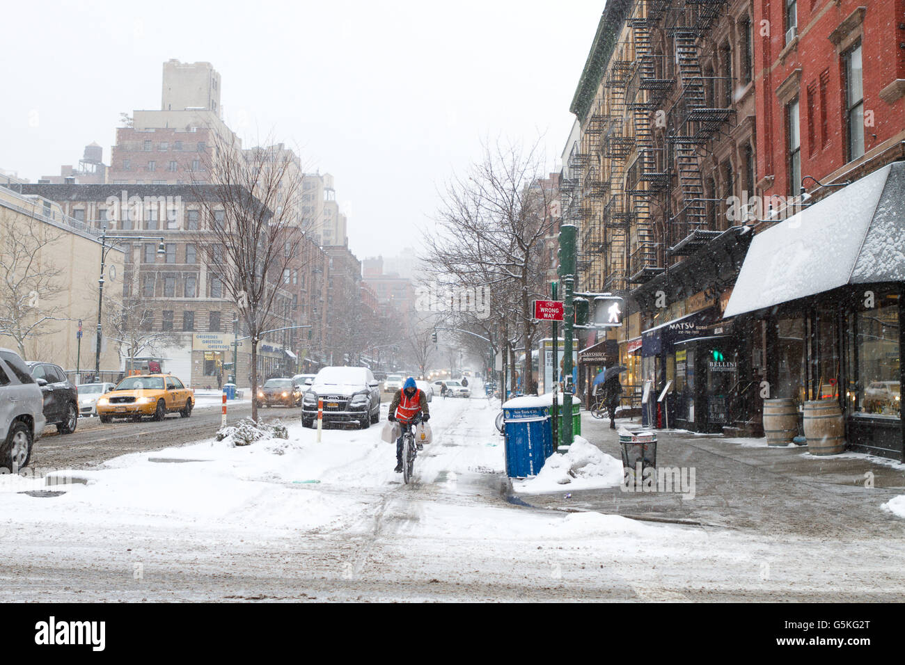 Food delivery bicyclist during a New York City snowstorm in the Upper West Side Stock Photo