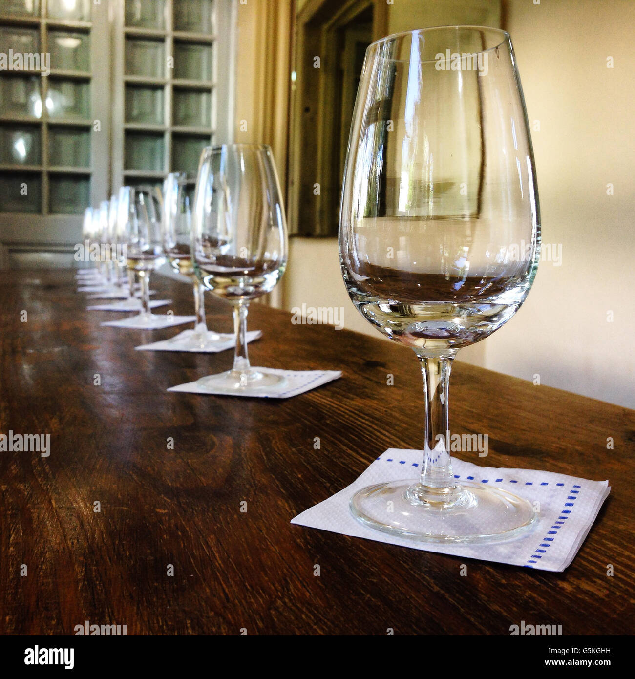 Wine glasses ready for a party on top of rustic table Stock Photo