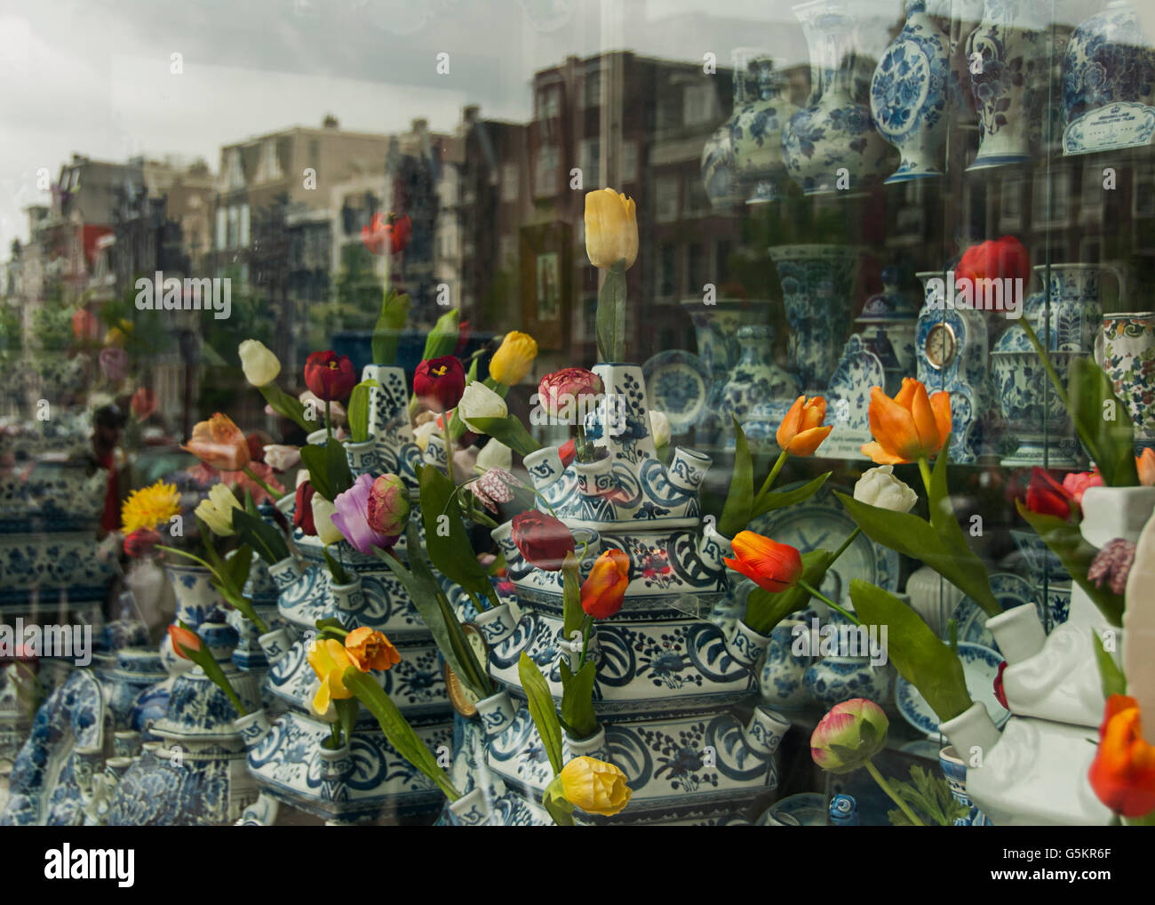 Amsterdam shop window reflection of buildings, tulips and delft Stock Photo Alamy