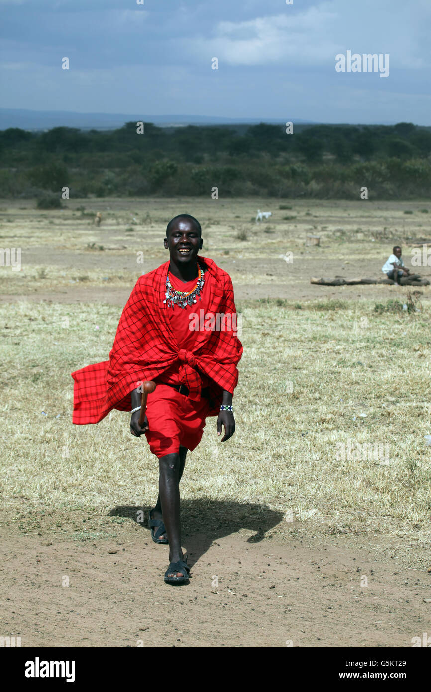 Young Masai warrior walking in a barren field in the Masai Village, Kenya, Africa. Stock Photo
