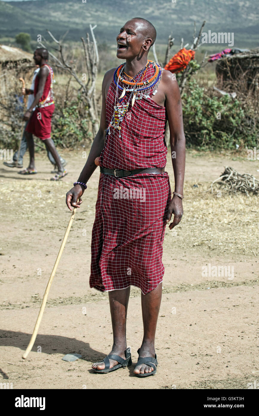 Young Masai man yelling in a Masai village, Kenya, Africa. Stock Photo