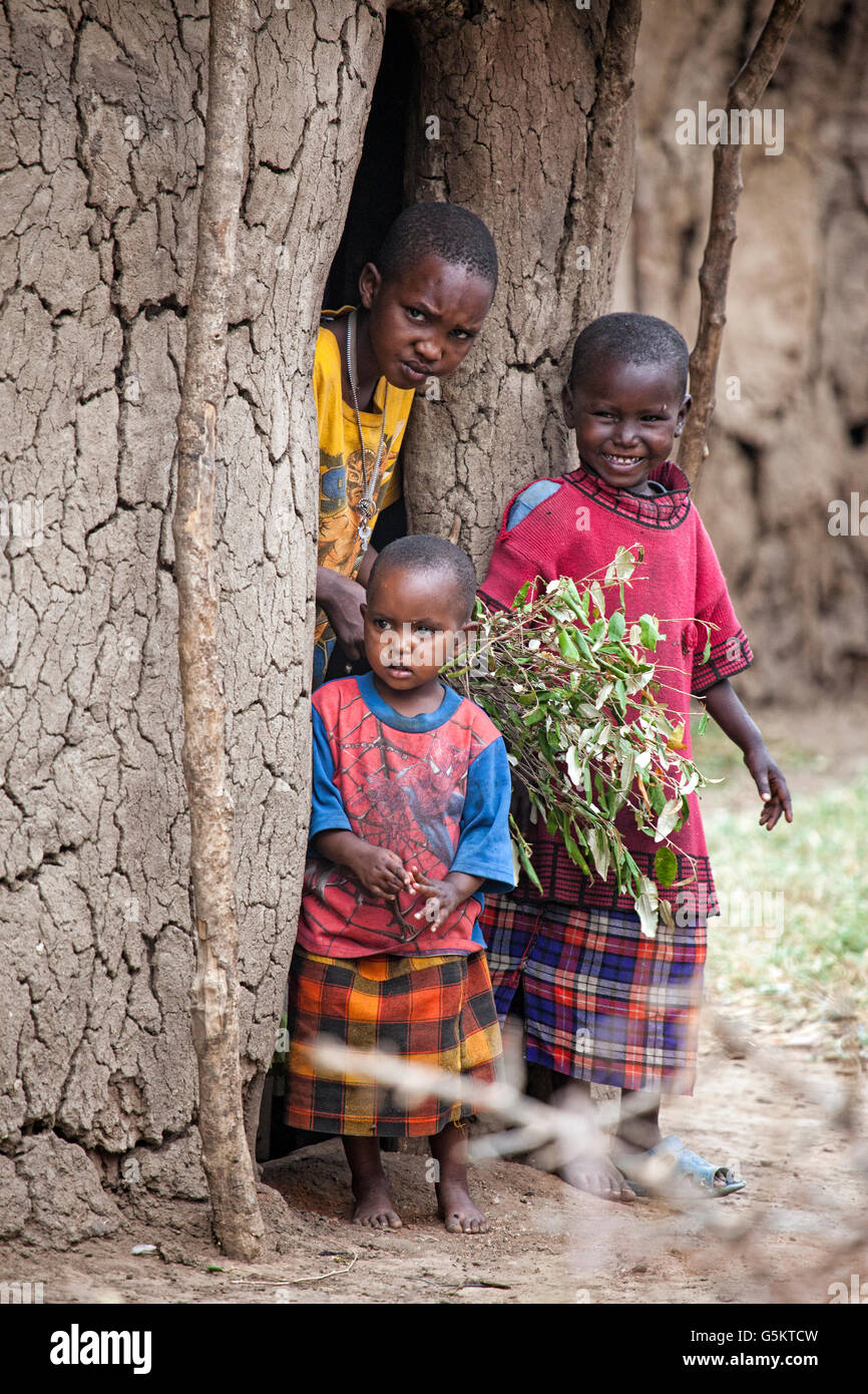 Group of small children outside a mud hut in the Masai Village, Kenya, Africa. Stock Photo