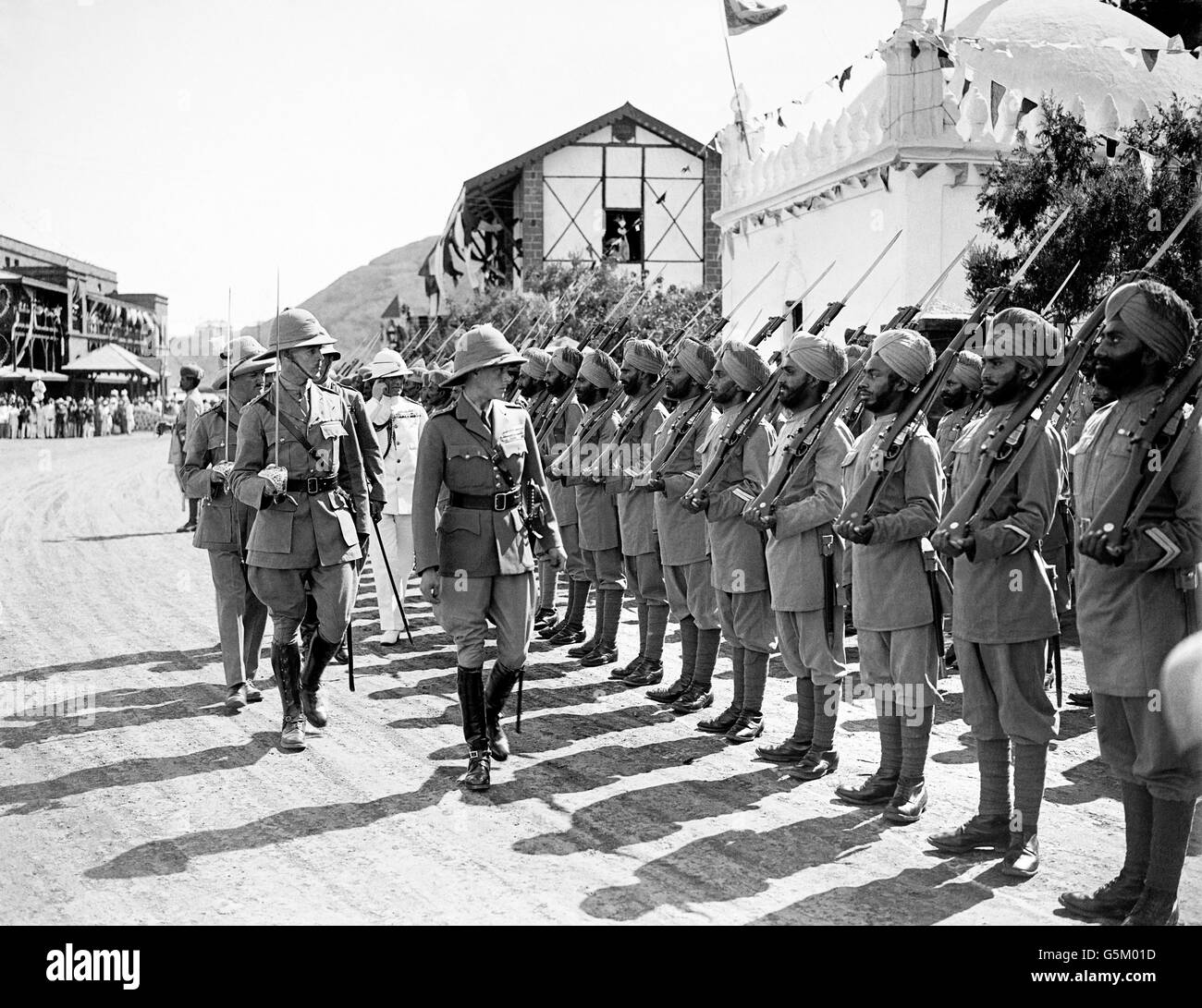 The Prince of Wales inspecting the Guard of Honour drawn from the 2nd Battalion, 19th Punjab Regiment (Indian Army). The Prince visited the Protectorate during his voyage to India and the Far East. Stock Photo