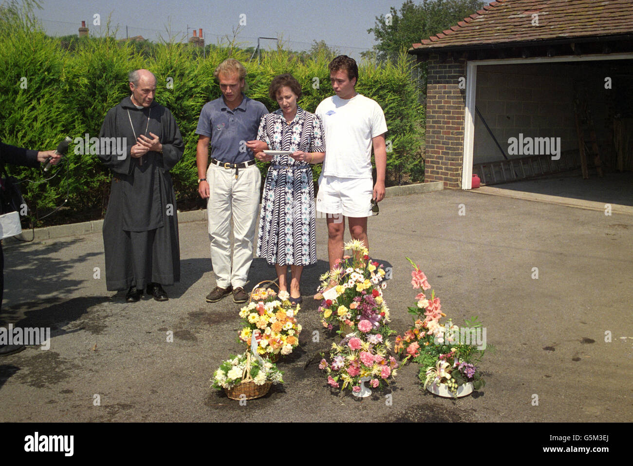 Mrs Jane Gow stands with her two sons James, right, Charles and The Rt Rev Peter Ball, the Bishop of Lewes, at the spot her husband, Conservative politician Ian Gow, died when his car was blown up by the IRA at their home in Hankham. Stock Photo