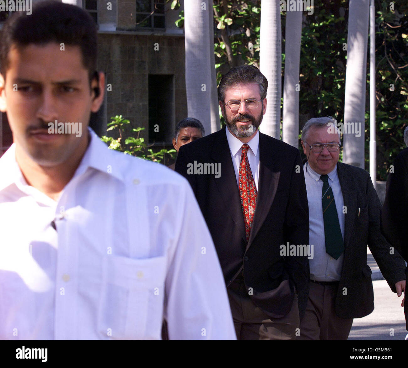 Sinn Fein President Gerry Adams, with colleague Pat Rice, being escorted to a Goverment meeting in Havana, by Cuban bodyguards. Adams called for the release of three Irishmen imprisoned by Colombian authorities after a meeting with senior Cuban government officials. Stock Photo