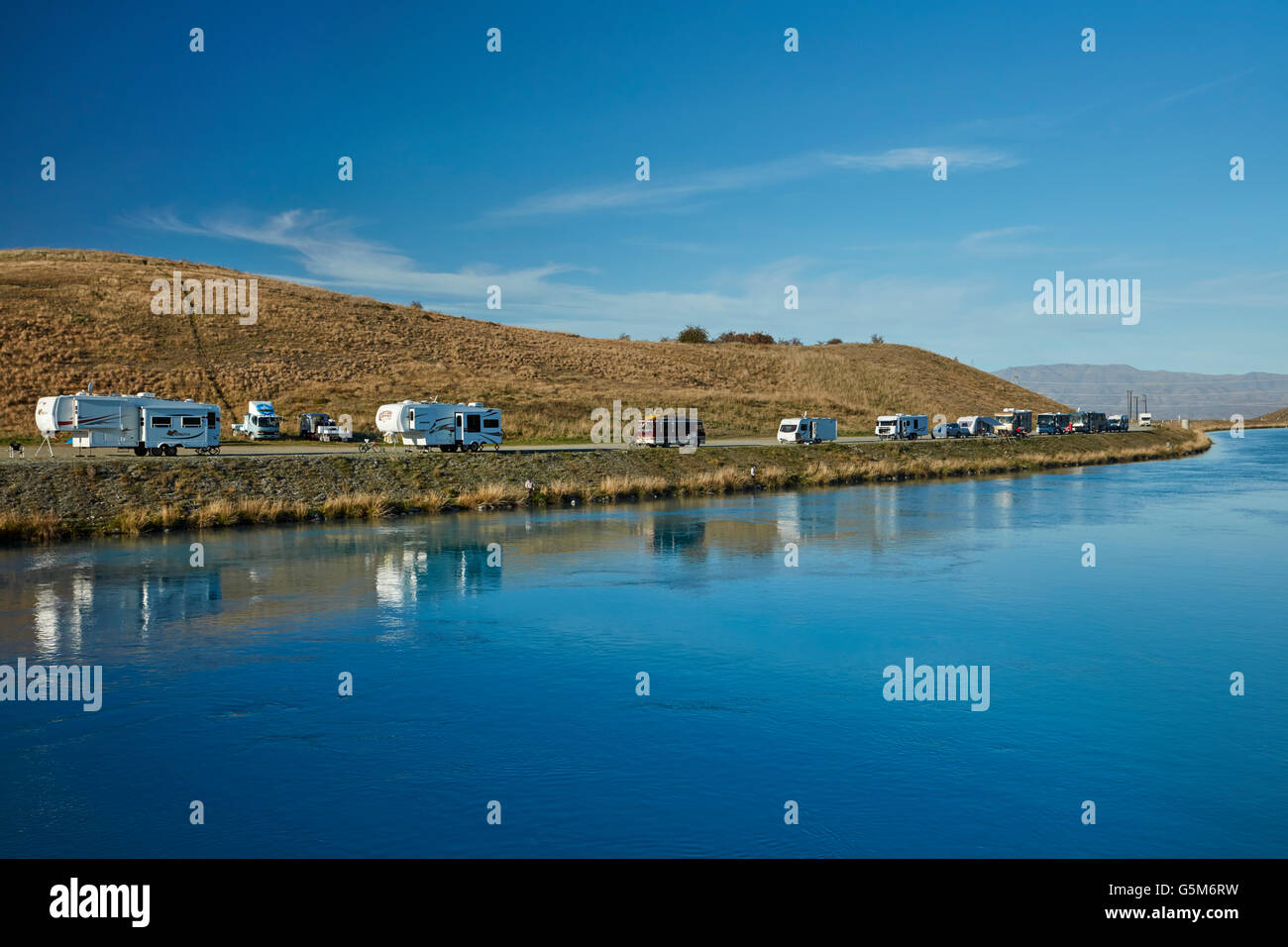 People fishing, caravans and campervans by Lake Ruataniwha, near Twizel, Mackenzie District, South Canterbury, New Zealand Stock Photo