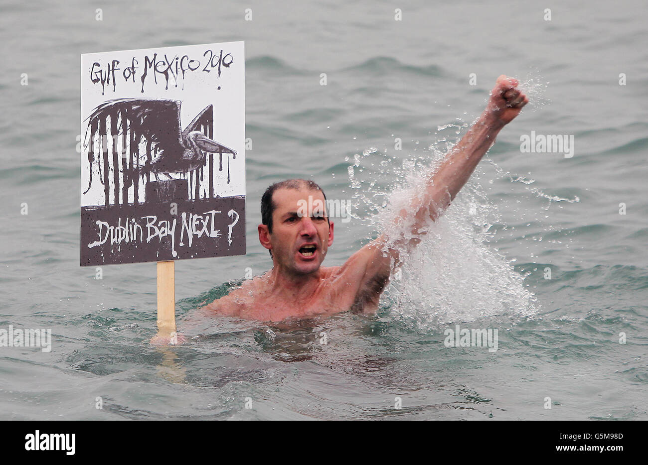Swimmer Paul Wright joins protesters as they gather at the 40 foot bathing pool in Sandycove to voice their safety fears for plans to allow exploration for oil in Dublin Bay off Dalkey. Stock Photo