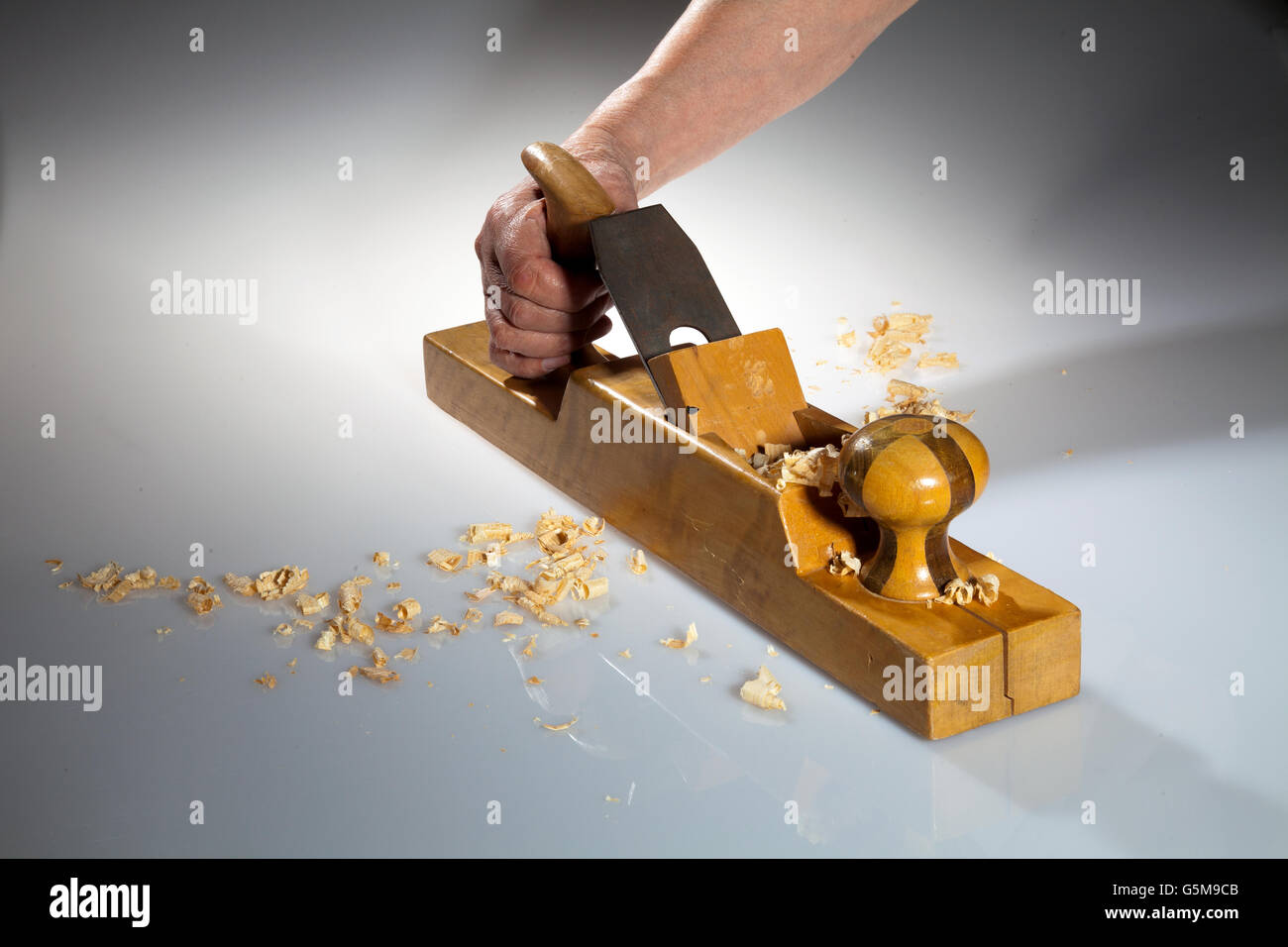 Hand holding wooden hand planer Stock Photo