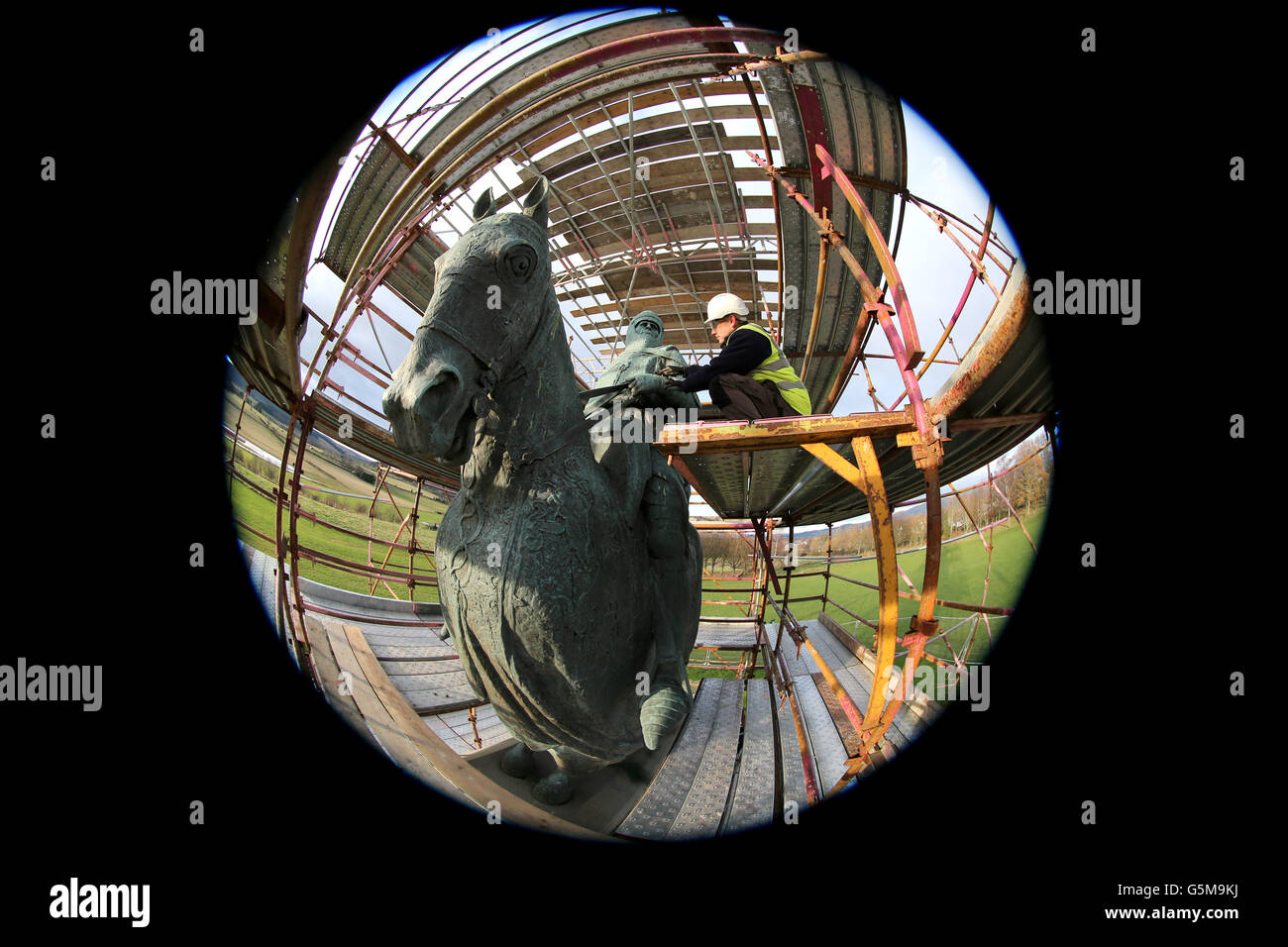 NOTE: PICTURE TAKEN WITH A FISHEYE LENS Mike Reid site manager, begins the restoration work on the weather-beaten statue of Robert the Bruce statue at the Battle of Bannockburn site, to restore the statue ahead of the 700th anniversary of the battle where Bruce is said to have defeated King Edward II's English army to secure an independent monarch for Scotland. Stock Photo