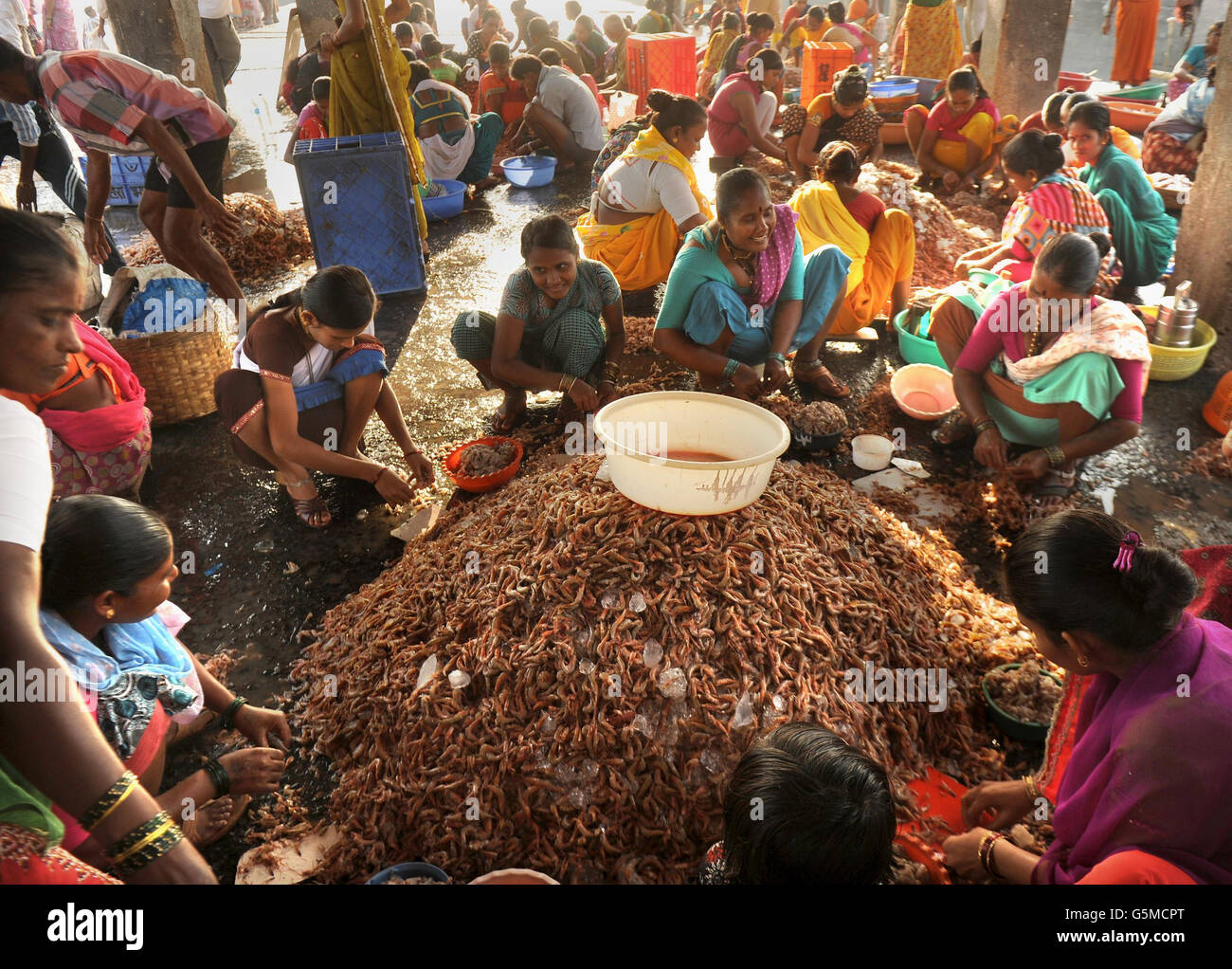 Women shell prawns at Sassoon Docks, the largest fish market in the ...