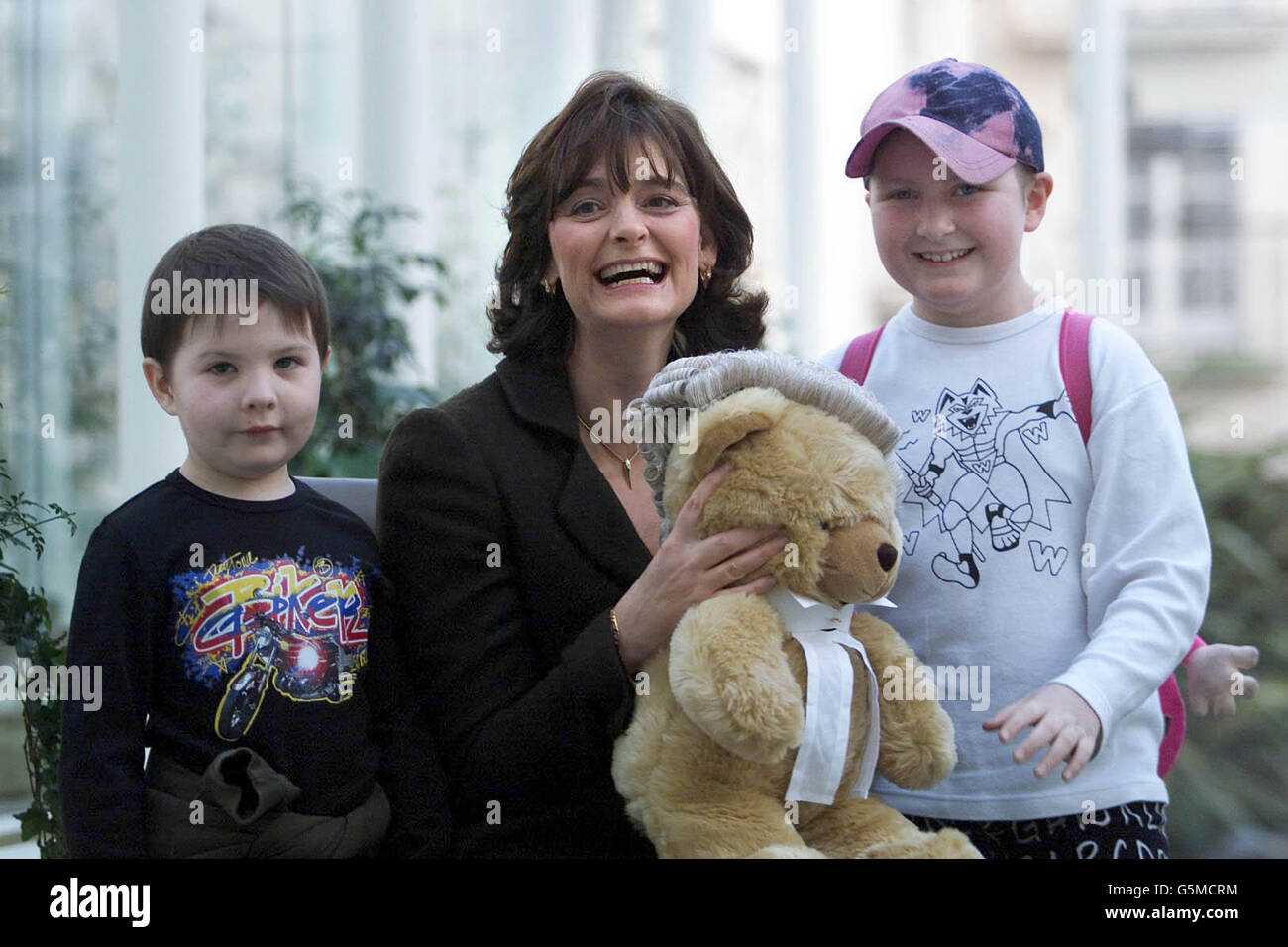 A delighted Cherie Booth, wife of British Prime Minister, Tony Blair, receives a teddy bear today from Cory Moore aged 6 (left) and Isobel Pearson Evans aged 8 both from The National Childrens Hospital, during her visit to Dublin. *Later Mrs Blair will be made an honorary bencher of the Kings Inn, an institution which trains barristers in Ireland. Stock Photo