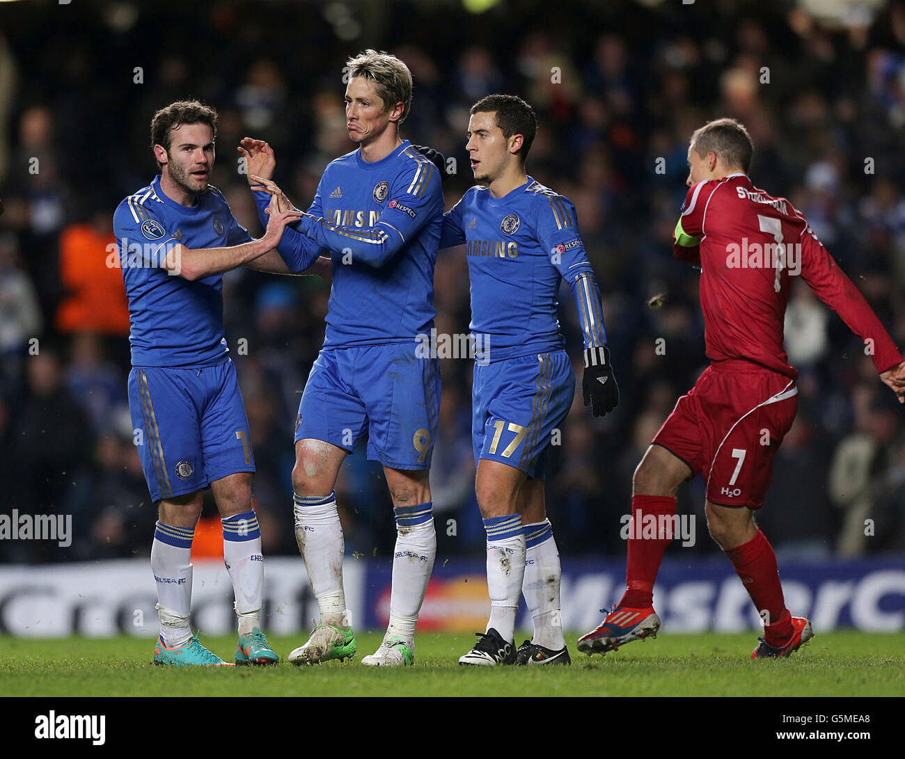 Chelsea's Fernando Torres (centre) celebrates with team-mates Juan Mata (left) and Eden Hazard ( secondright) after scoring his team's second goal Stock Photo