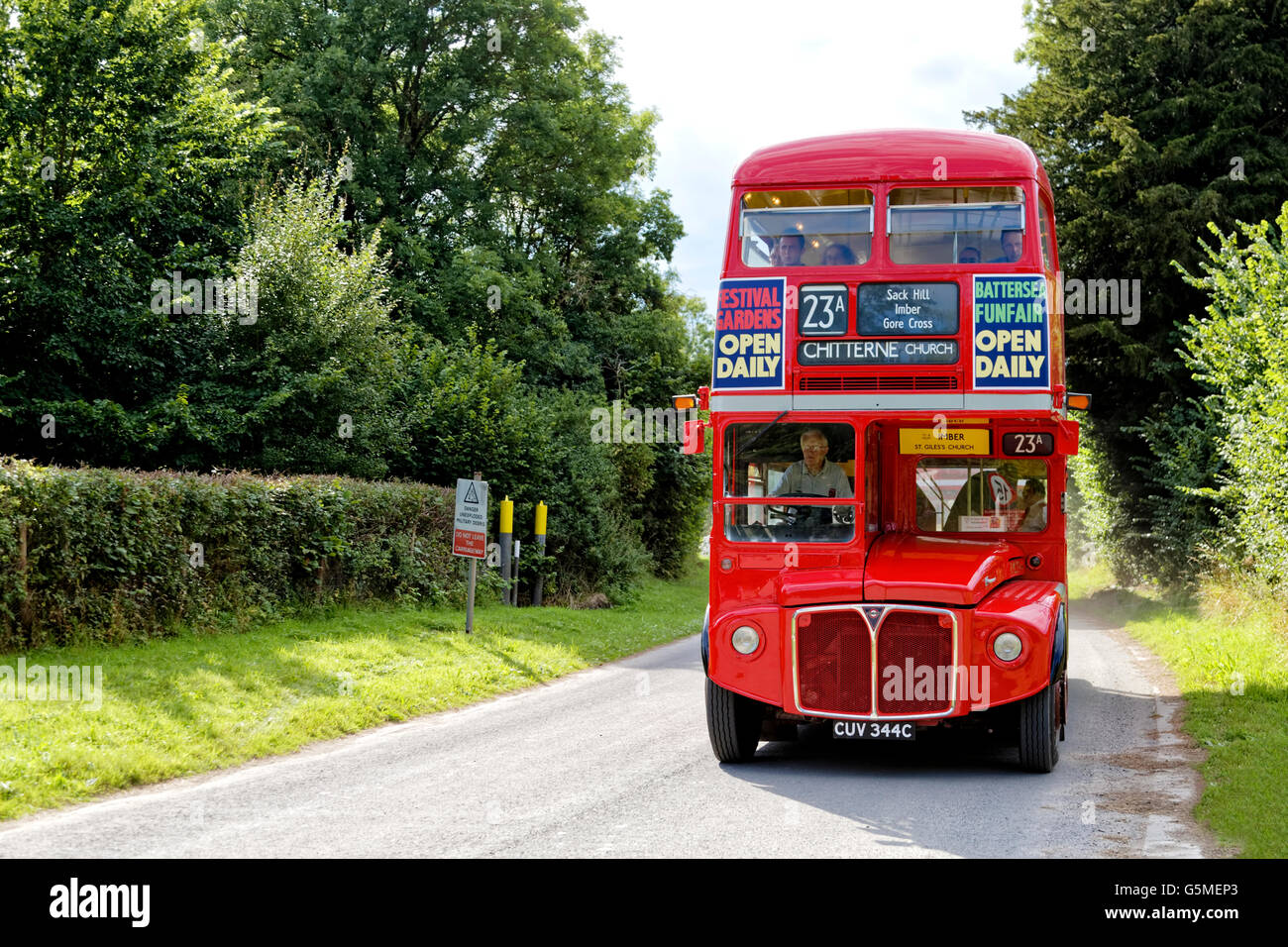 A former London Transport double decker bus makes its way through Imber village on Salisbury Plain on the 2015 Imberbus Day. Stock Photo