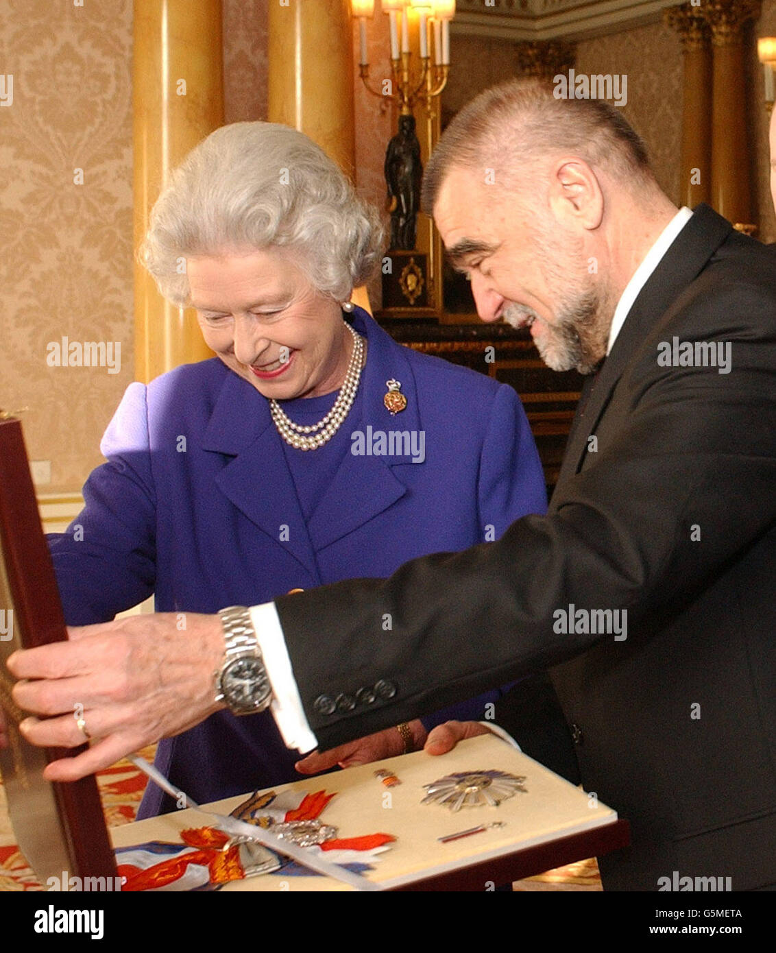Britain's Queen Elizabeth II exchanges gifts with the President of Croatia Stjepan Mesic at Buckingham Palace in central London. Mesic was in London as part of a three-day visit to the Britain, his first as head of state for Croatia. Stock Photo