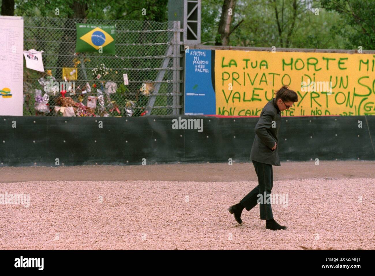A fan pays tribute to Ayrton Senna at the place where he died at the Imola Circuit Stock Photo