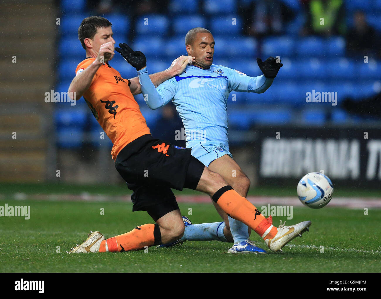 Coventry City's David McGoldrick and Portsmouth's L'ubomir Michalik in action during the npower Football League One match at the Ricoh Arena, Coventry. Stock Photo