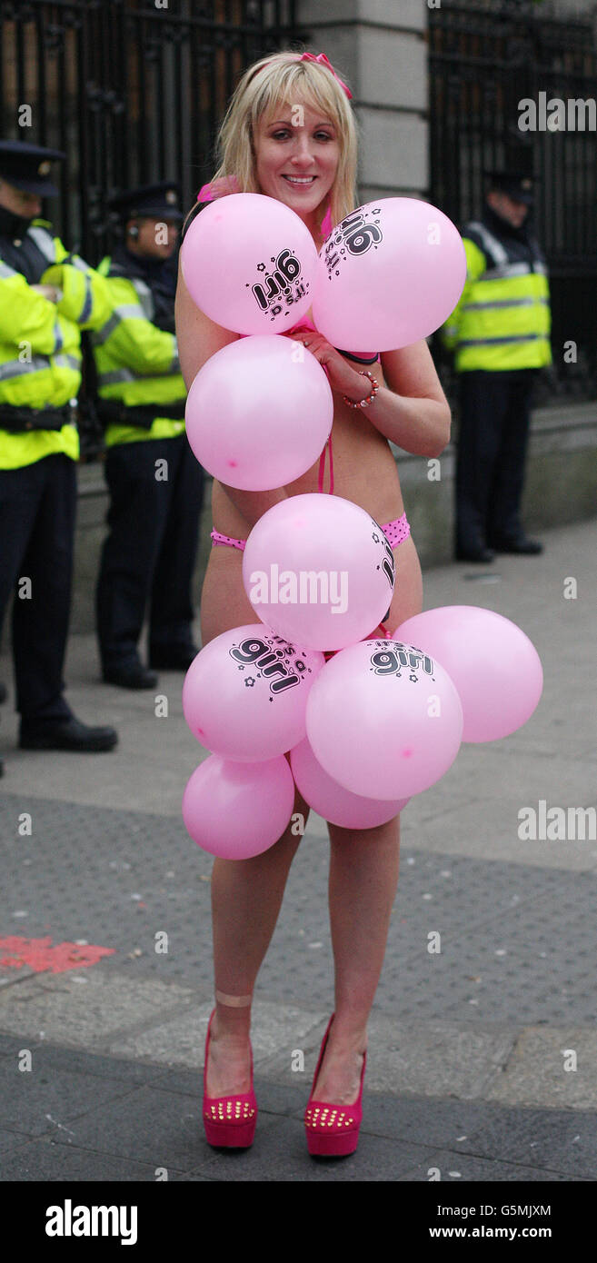 Aisling Fitzgibbon aka 'The Girl Against Fluoride' strips off outside Leinster House to highlight the cost of the addition of chemicals including fluoride to the water supply as trade union members march through Dublin City Centre in opposition to Austerity. Stock Photo