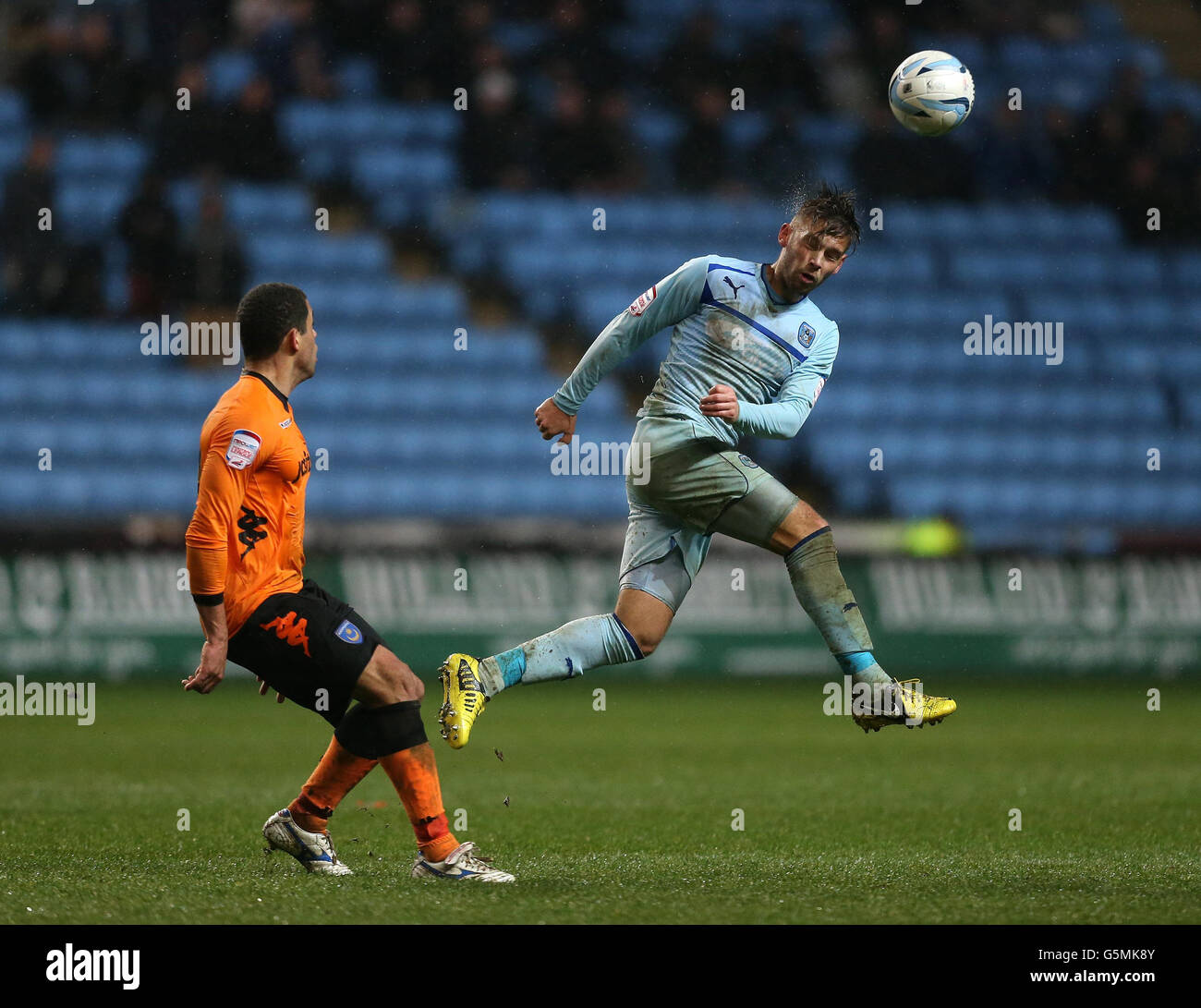 Coventry City's James bailey and Portsmouth's Darel Russell in action during the npower Football League One match at the Ricoh Arena, Coventry. Stock Photo